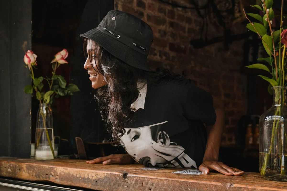 A smiling café owner at the service window.